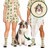 A person modeling a matching pajama set and socks with a dog sitting beside them, plus a circular inset showing a dog portrait printed on the pajama top. The set has a beige base with a repeating cactus and dog print, photographed on a white studio background.