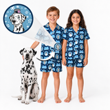 Two smiling children wearing matching blue Frosty the Snowman pajamas featuring a personalized Dalmatian illustration, standing beside a Dalmatian dog, with an inset highlighting the custom pet artwork.