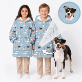 Two smiling children wearing matching light blue personalized winter hoodies featuring snowmen and custom dog illustrations, standing beside a black, brown, and white dog, with an inset highlighting the pet artwork.