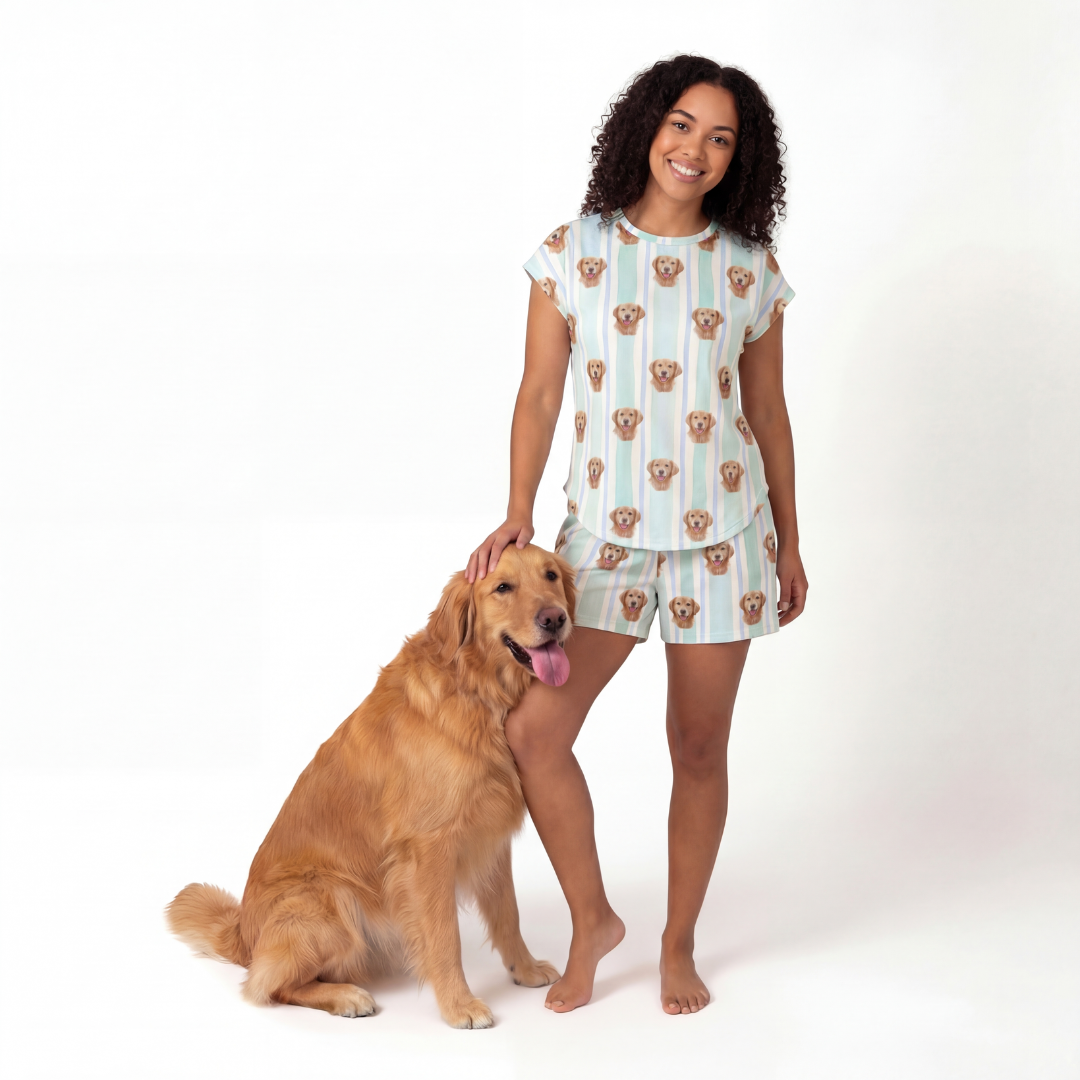 Woman wearing a fitted pajama standing next to a dog on a white background