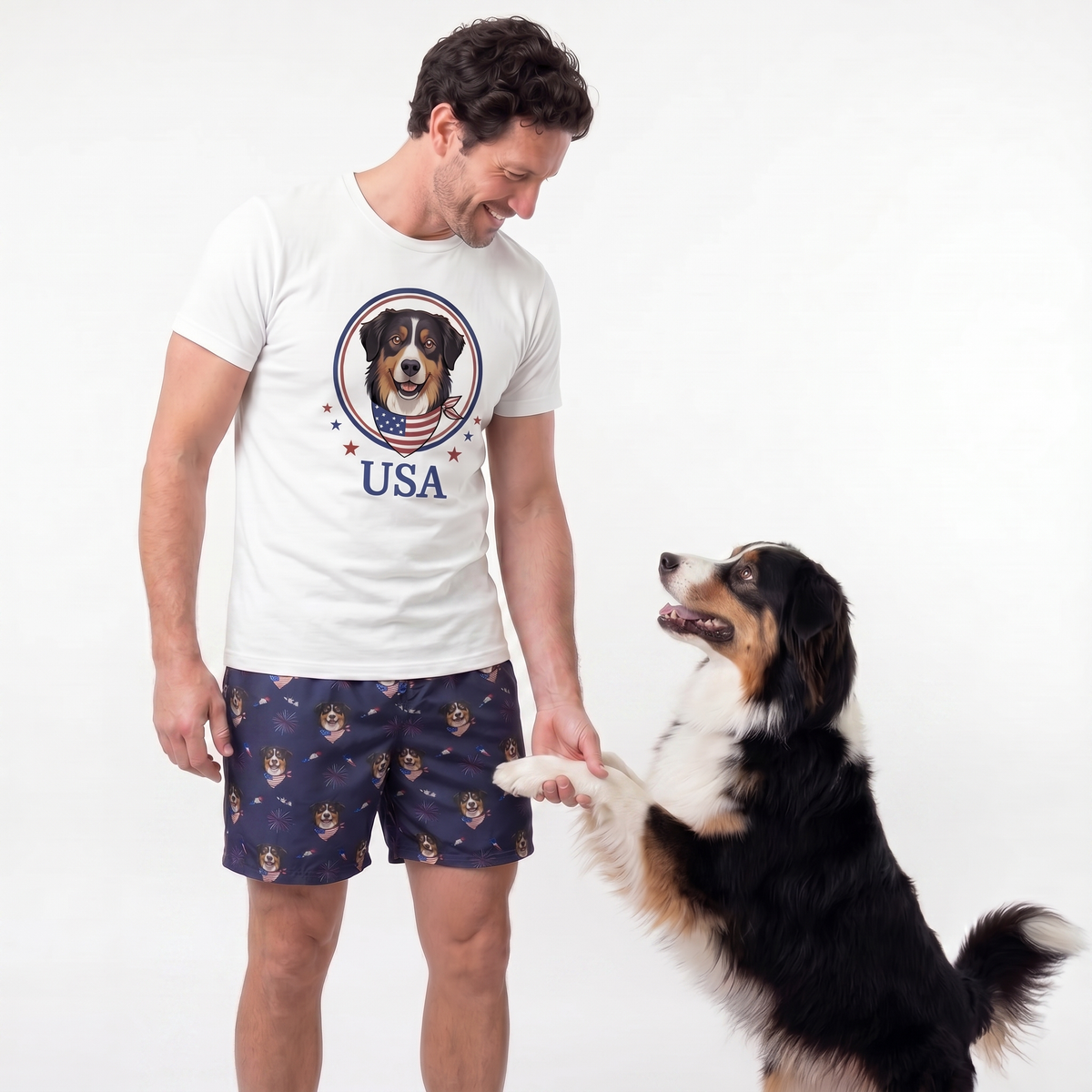 Man wearing a white t-shirt with a dog graphic and 'USA' text, standing next to a dog on a white background