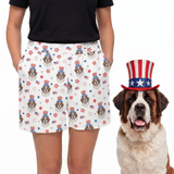 Person wearing a shorts with a dog pattern and a dog wearing an American flag hat on a white background[UncleSam]