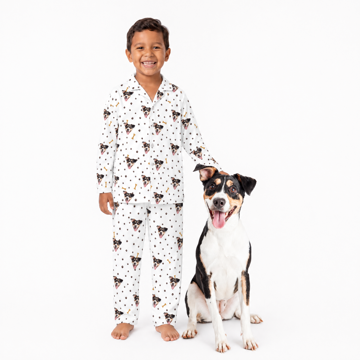 Child wearing a white pajama set standing next to a dog on a white background
