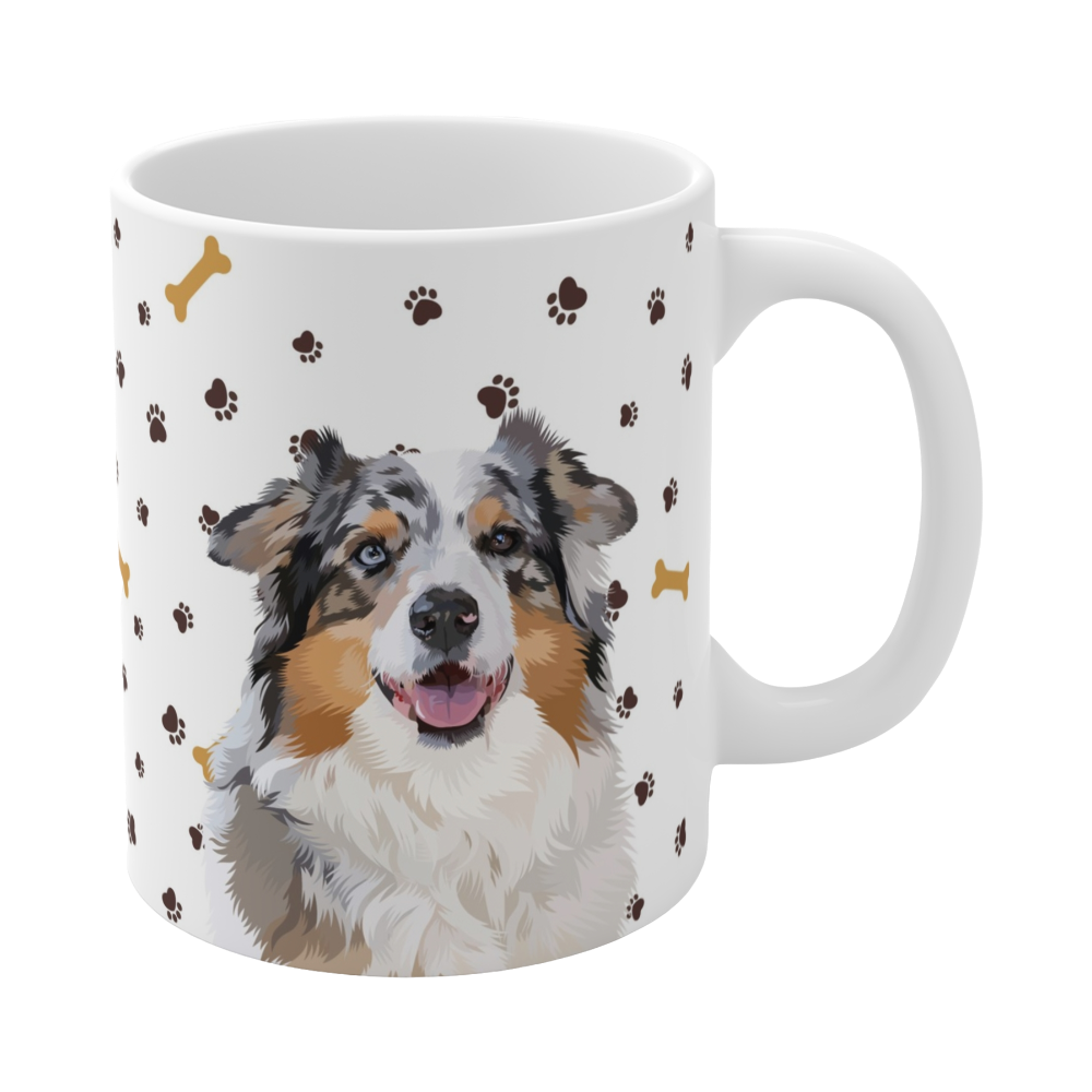 Close up of white ceramic mug with paws and bones pattern, featuring a smiling, multicolored Australian Shepherd