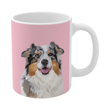 Pink ceramic mug featuring a smiling, multicolored Australian Shepherd
