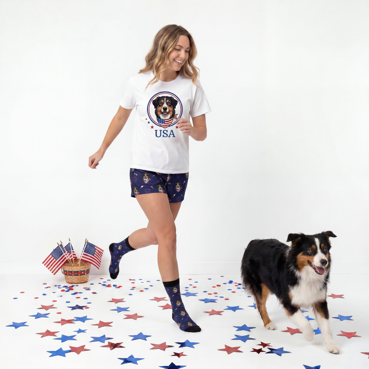 Woman wearing a white t-shirt with a dog graphic and 'USA' text, standing next to a dog on a white background with star decorations.