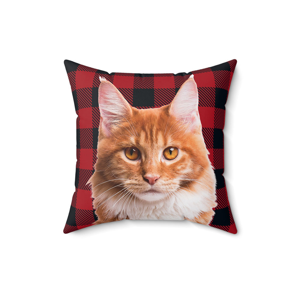 Pillow with a red and black checkered pattern featuring an orange cat's face.