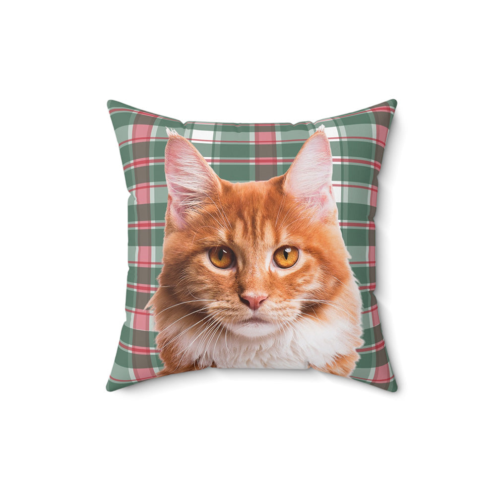 A square pillow showcasing a realistic photo of an orange cat on a festive green, red, and white plaid background.