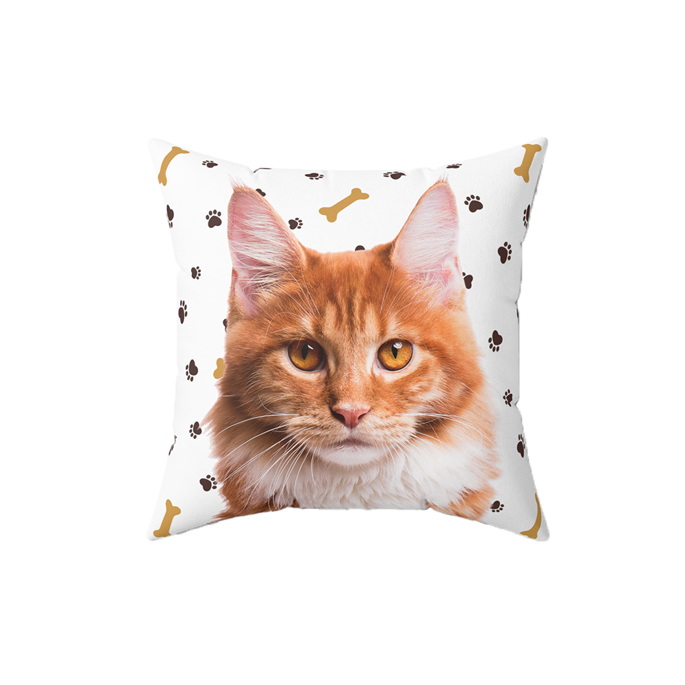 White pillow with paws and bones, it features a portrait of a cat.