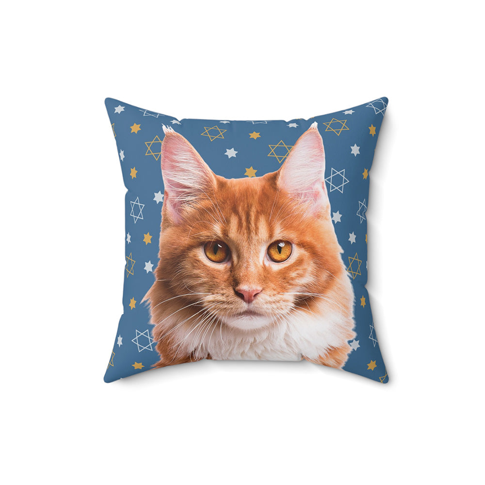 Square throw pillow with a realistic portrait of an orange tabby cat on a blue background decorated with yellow and white Stars of David.