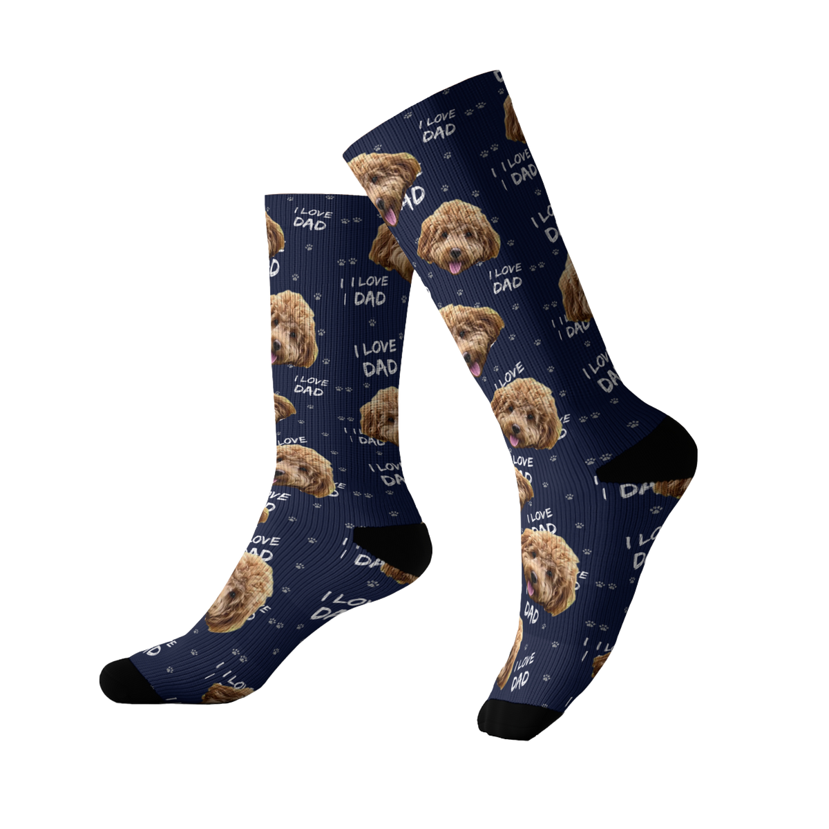 Navy blue socks featuring a repeating pattern of a fluffy brown dog’s face with small paw prints and the phrase “I LOVE DAD” scattered throughout the design. The socks have black toes and heels.
