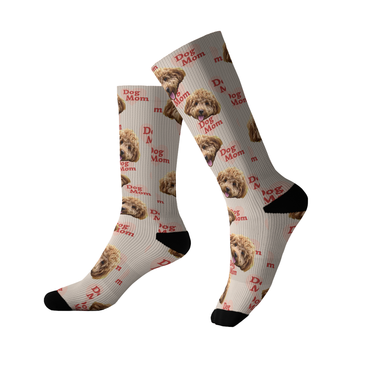 Light beige socks featuring a repeating pattern of a fluffy brown dog’s face along with the phrase “Dog Mom” printed in red across the design. The socks have black toes and heels.