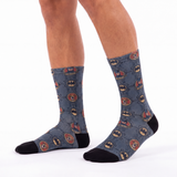Blue socks with batman logo pattern worn by a person on a white background