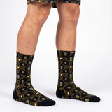 Person wearing black socks with batman patterns on a white background