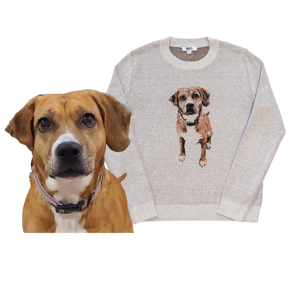 A custom knit pet sweater with a portrait of a dog printed on the front, displayed next to the actual dog.