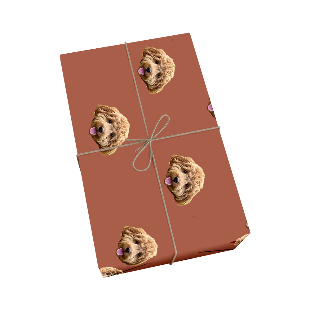 Custom pet wrapping paper in cocoa brown color featuring repeating pattern of dog portraits with golden ribbon design