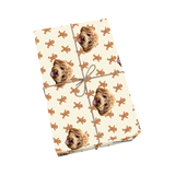 Cream pet wrapping paper with dog portraits and gingerbread man shapes.