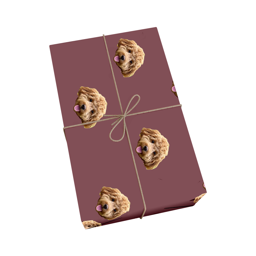 Custom pet wrapping paper in maroon color featuring repeating pattern of dog portraits with golden ribbon design
