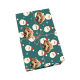Teal pet wrapping paper with dog portraits, Santa faces, and snowflakes.