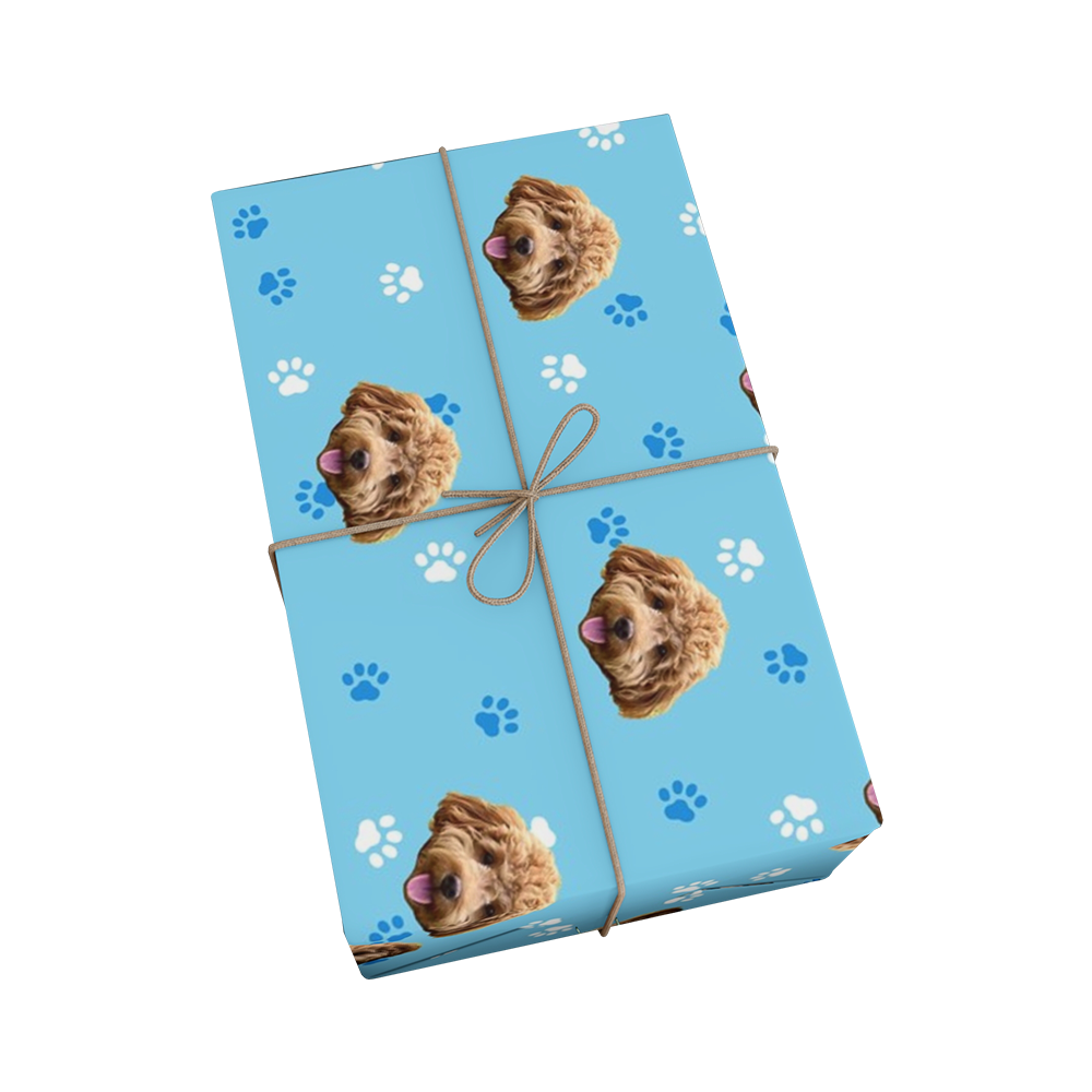 Light blue wrapping paper with paws and dog faces