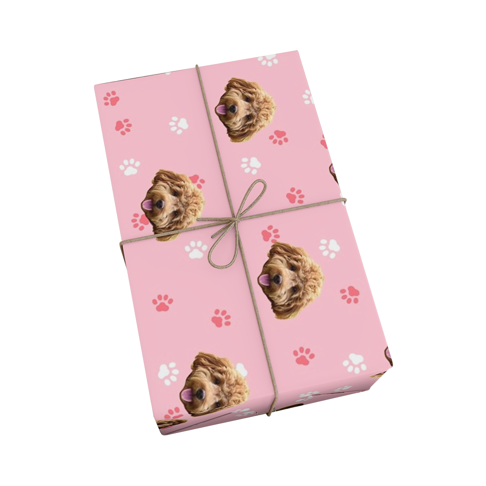 Pink wrapping paper with paws and dog faces